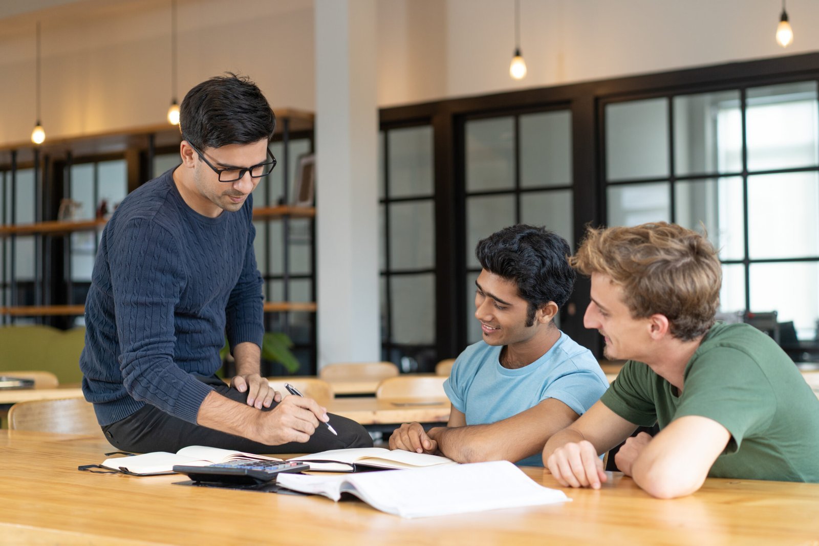 Home serious teacher checking assignment two students scaled.jpg